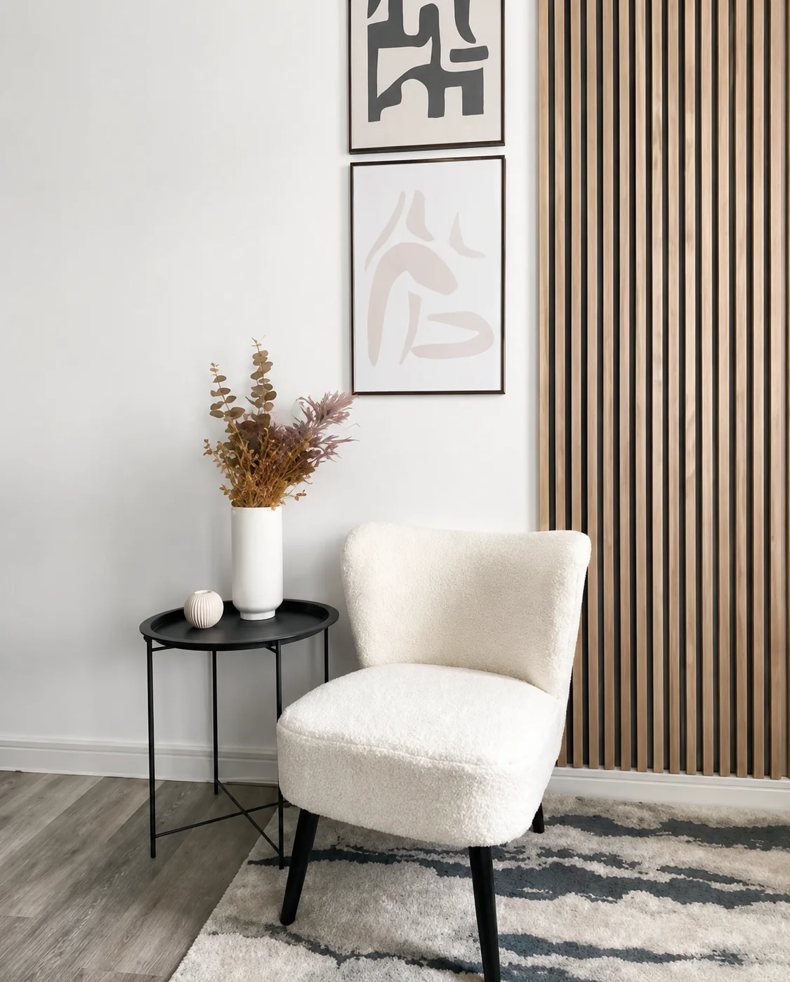 Light oak slat wall beside white lounge chair
